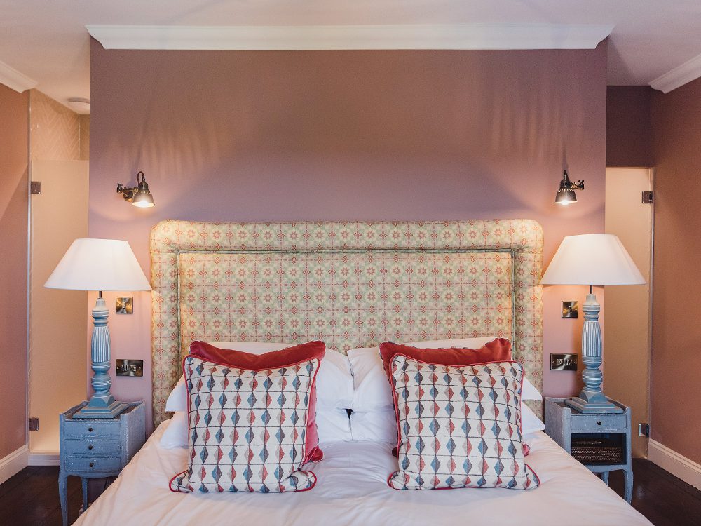 Salmon bedroom at Kingshill farmhouse on the Elmley Nature Reserve. Interior design & styling by Rowan Plowden Design.